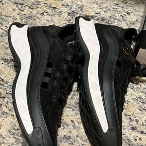 Lightly worn Chanel sneakers in black and white
